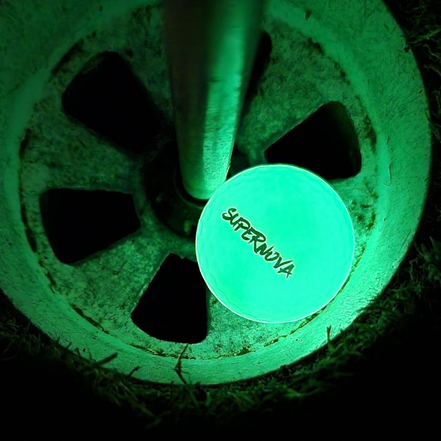 A SuperNova, glow in the dark golf ball hit into a hole!